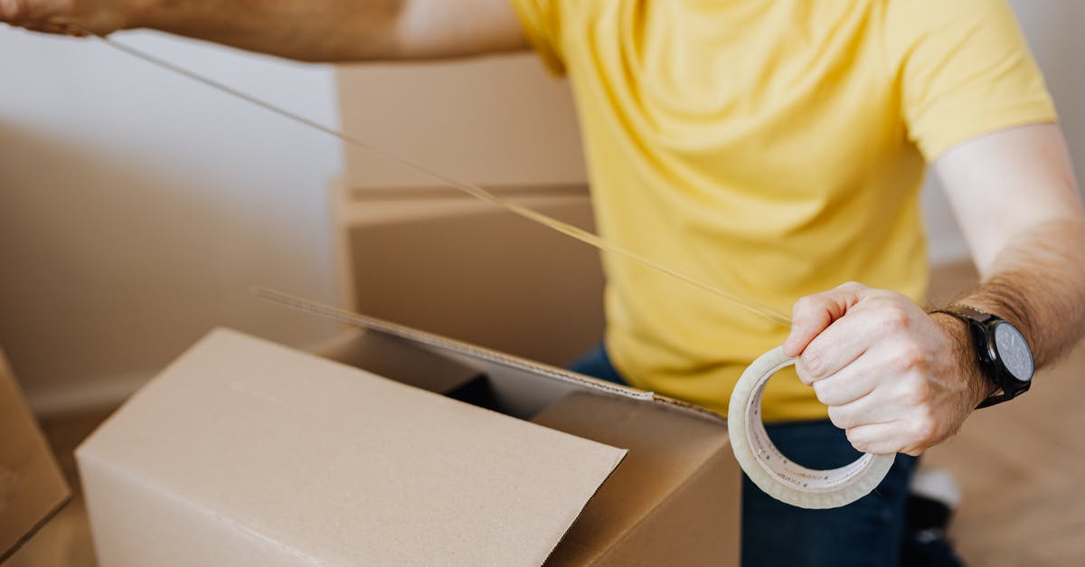 What is this yellow "fat" thing on my bacon - Crop man with cardboard boxes while packing belongings What is this yellow "fat" thing on my bacon - Crop man with cardboard boxes while packing belongings
