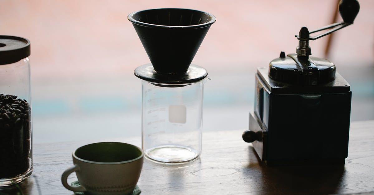 What kind of coffee grinder is best? - From above of manual coffee grinder with pour over coffeemaker placed in wooden table with ceramic cup and glass jug with roasted beans in morning What kind of coffee grinder is best? - From above of manual coffee grinder with pour over coffeemaker placed in wooden table with ceramic cup and glass jug with roasted beans in morning