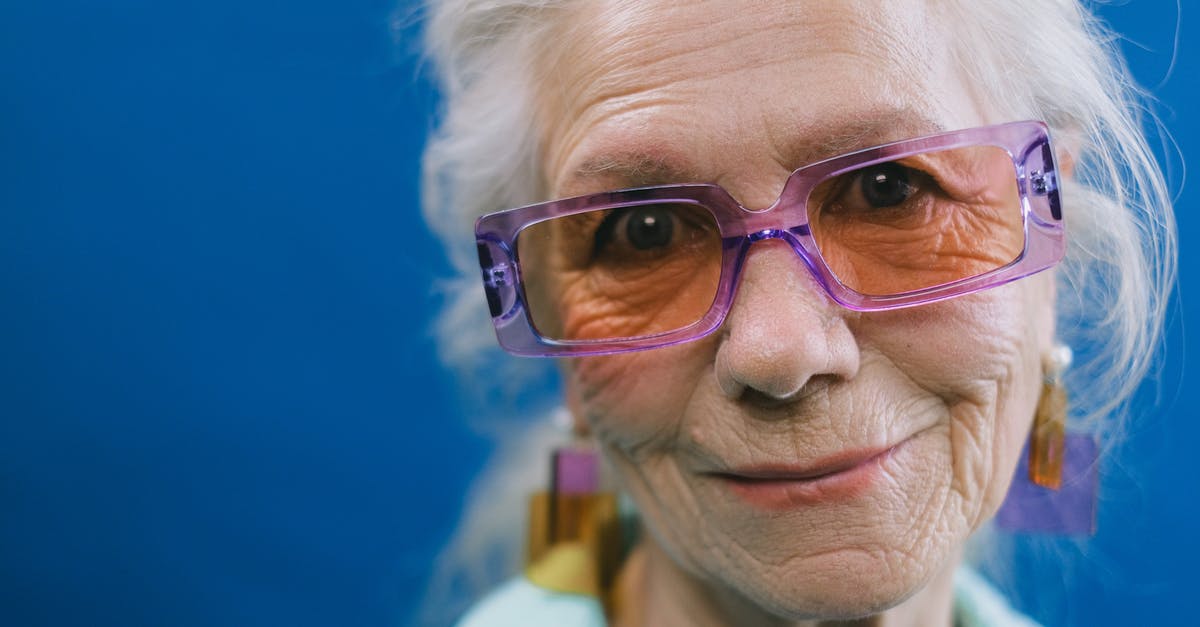 What kind of glass is this? - Smiling senior gray haired woman What kind of glass is this? - Smiling senior gray haired woman