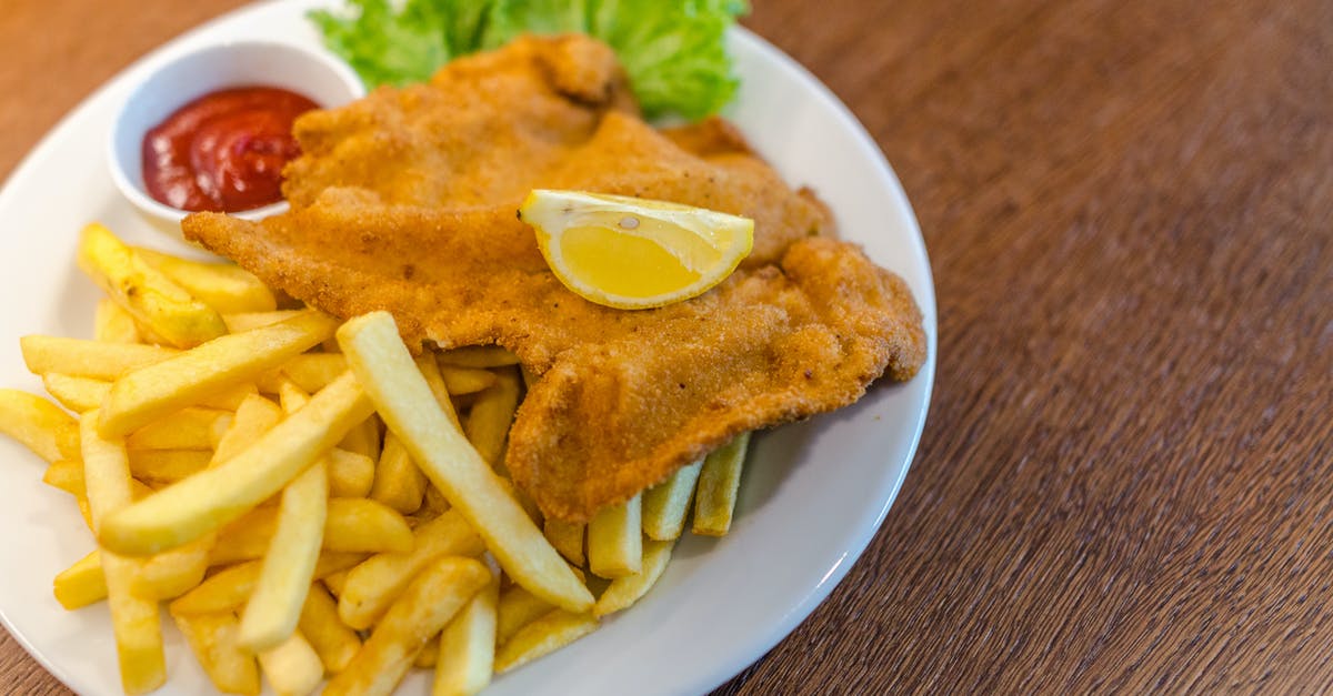 What kind of meat to use for Wiener Schnitzel? - Potato Fries With Fried Meat and Red Sauce on Round White Ceramic Plate What kind of meat to use for Wiener Schnitzel? - Potato Fries With Fried Meat and Red Sauce on Round White Ceramic Plate