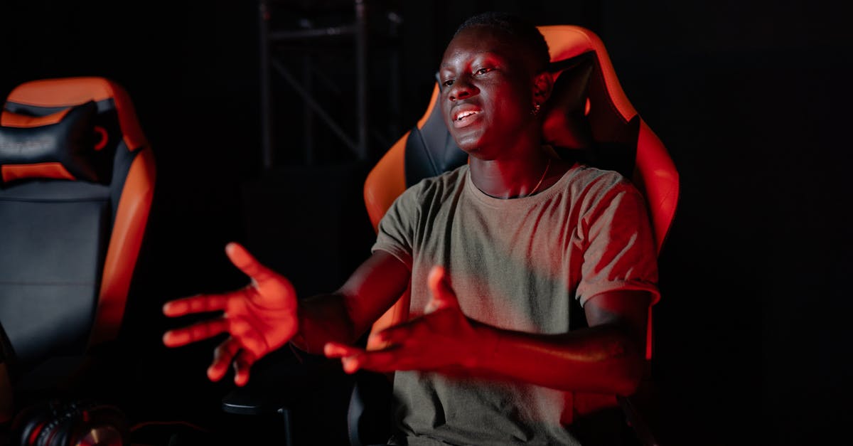 What kind of reaction is this? - Man in Gray Crew Neck T-shirt Sitting on Red Chair What kind of reaction is this? - Man in Gray Crew Neck T-shirt Sitting on Red Chair