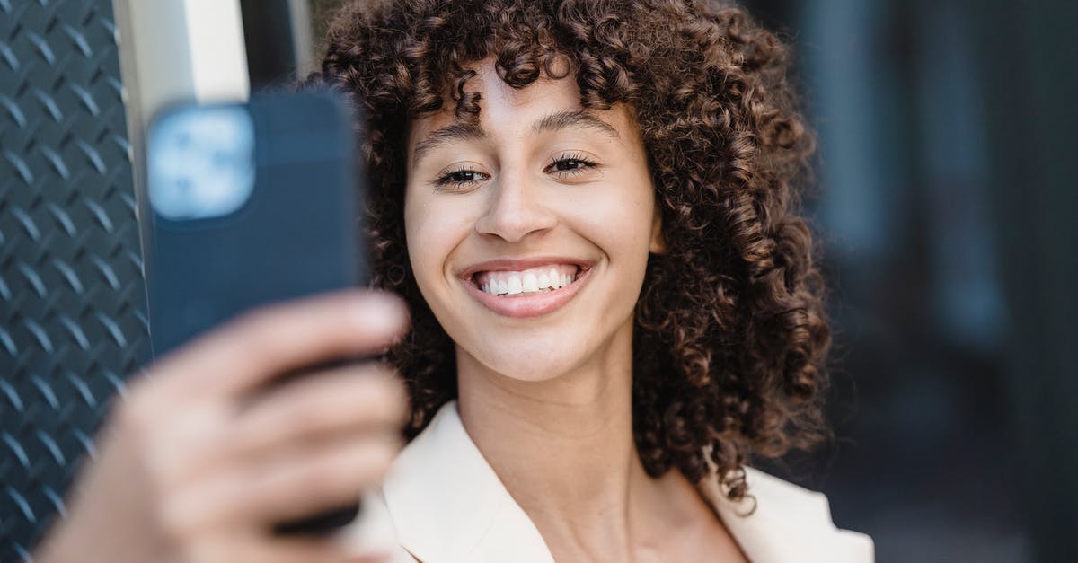 What kind of steak to use for fajitas? - Positive young ethnic female with curly brown hair taking self shot on cellphone in town on blurred background What kind of steak to use for fajitas? - Positive young ethnic female with curly brown hair taking self shot on cellphone in town on blurred background