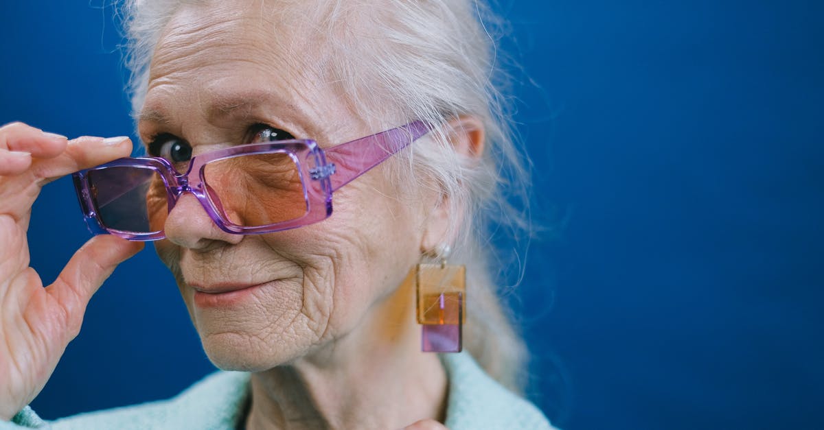 What kind of yeast is this? - Portrait of elegant smiling gray haired elderly female wearing purple sunglasses and earrings looking at camera against blue background What kind of yeast is this? - Portrait of elegant smiling gray haired elderly female wearing purple sunglasses and earrings looking at camera against blue background