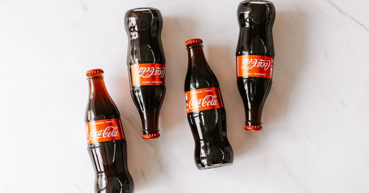 What made my pancakes taste fizzy? - High angle composition of bottles of soft drink placed on white marble table What made my pancakes taste fizzy? - High angle composition of bottles of soft drink placed on white marble table