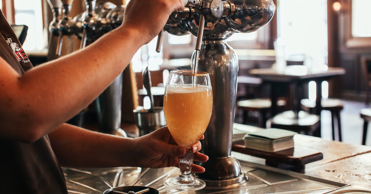 What makes alcohol-free beer sweet? - Person Pouring Orange Liquid on Clear Drinking Glass What makes alcohol-free beer sweet? - Person Pouring Orange Liquid on Clear Drinking Glass