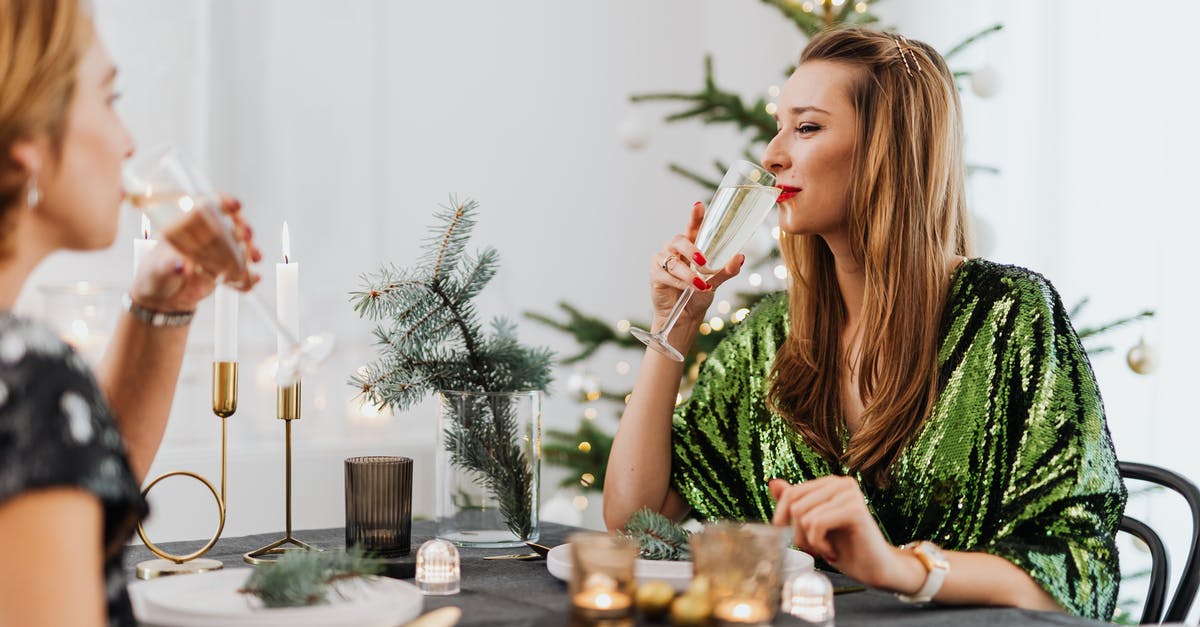 What makes creme brulee set? - Woman in Green Sleeveless Shirt Sitting on Chair Holding Drinking Glass