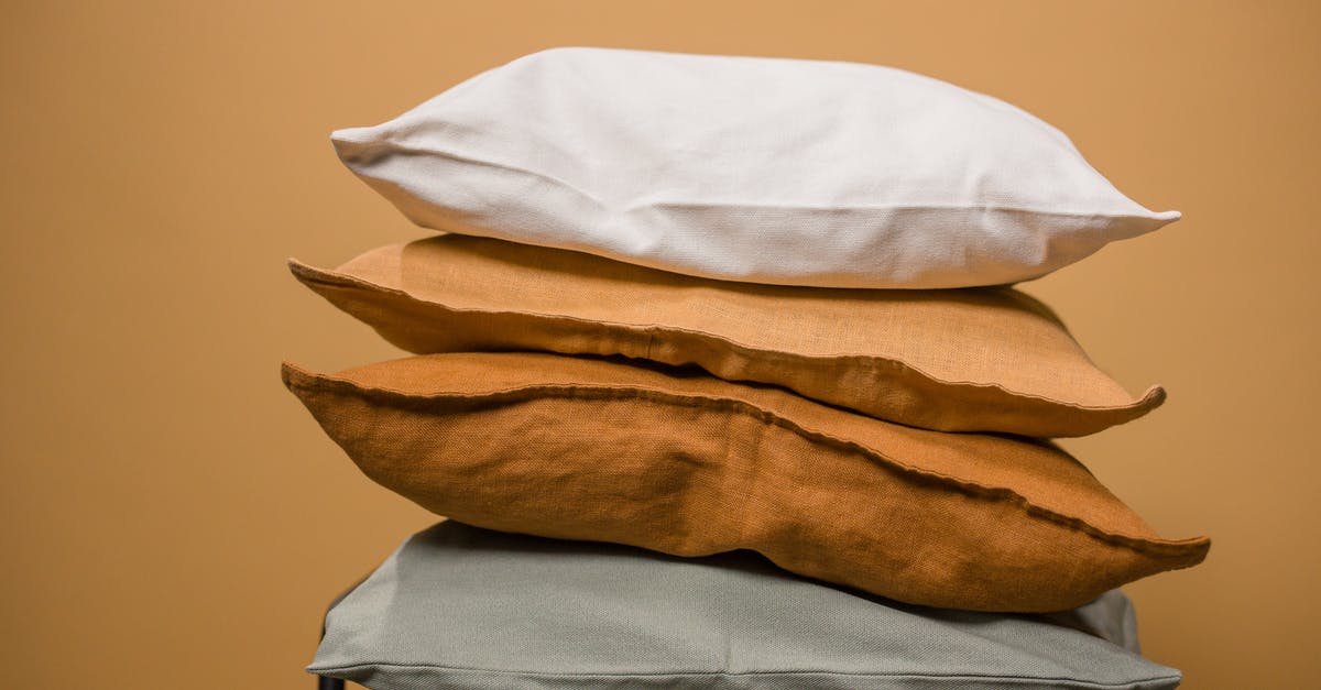 What makes the difference between domed and flat cookies? - Stack of different colorful pillows folded and placed in stack on chair isolated on dark beige background What makes the difference between domed and flat cookies? - Stack of different colorful pillows folded and placed in stack on chair isolated on dark beige background