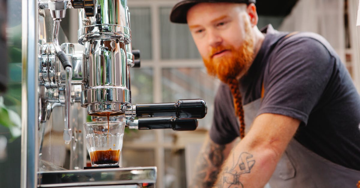 What material is best for a pour over coffee brewer? - Hipster barista against coffee maker brewing espresso in kitchen What material is best for a pour over coffee brewer? - Hipster barista against coffee maker brewing espresso in kitchen