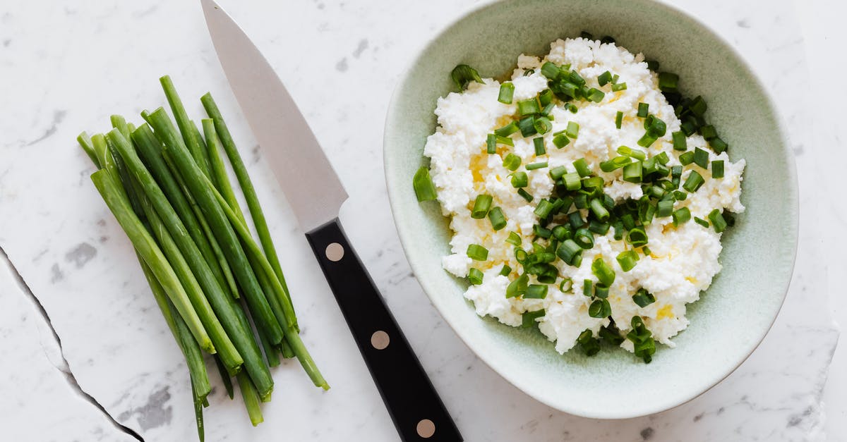 What oils are "required" for a decent home kitchen? - Top view of fresh salad with cottage cheese chopped onion oil and knife fresh greenery on white table with crack What oils are "required" for a decent home kitchen? - Top view of fresh salad with cottage cheese chopped onion oil and knife fresh greenery on white table with crack