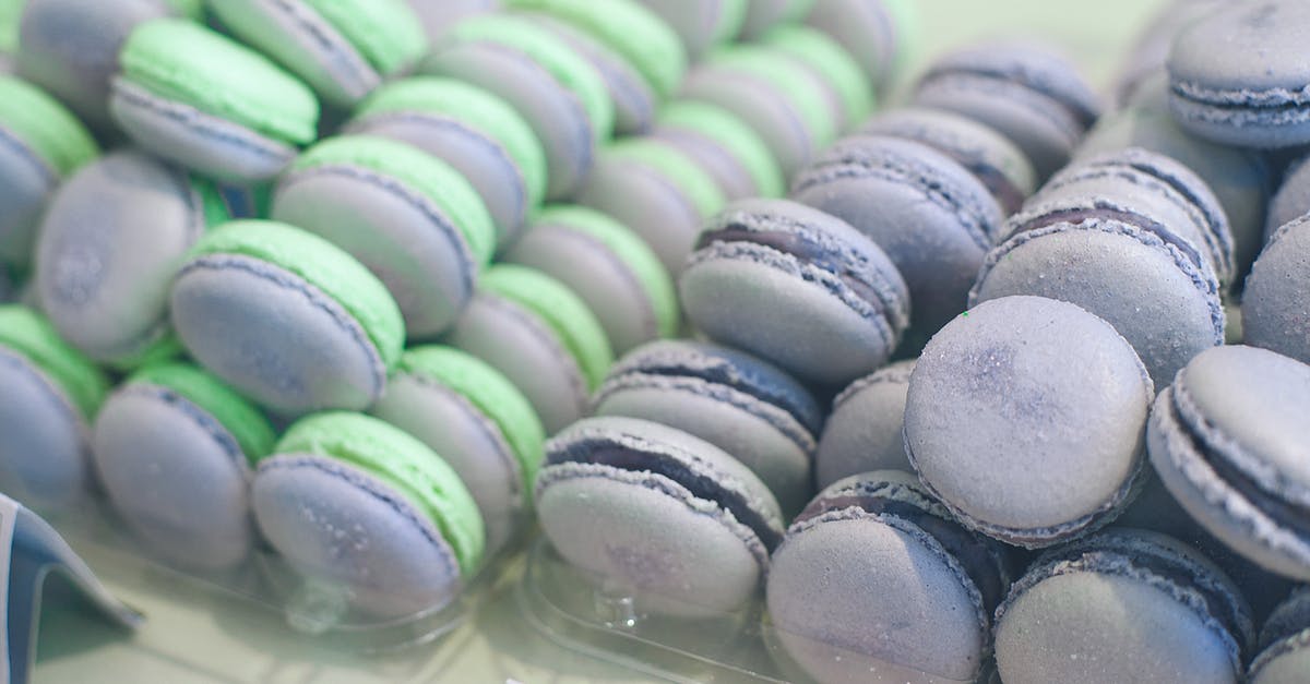 What other cookies/biscuits were traditionally baked in shell shaped forms like this one? - From above of assorted tasty meringue biscuits with bright filling between crunchy baked round shaped layers