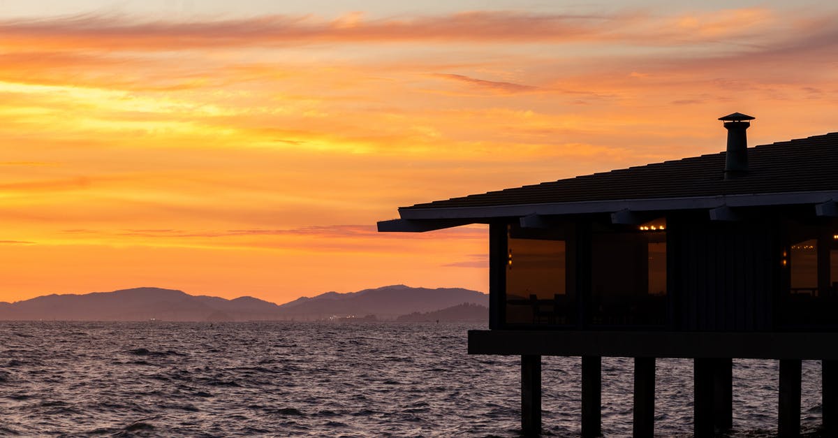 What property makes a liquid soapy/bubbly? - Building on stilts on rippling river near silhouette of rough mountains on picturesque golden sunset What property makes a liquid soapy/bubbly? - Building on stilts on rippling river near silhouette of rough mountains on picturesque golden sunset