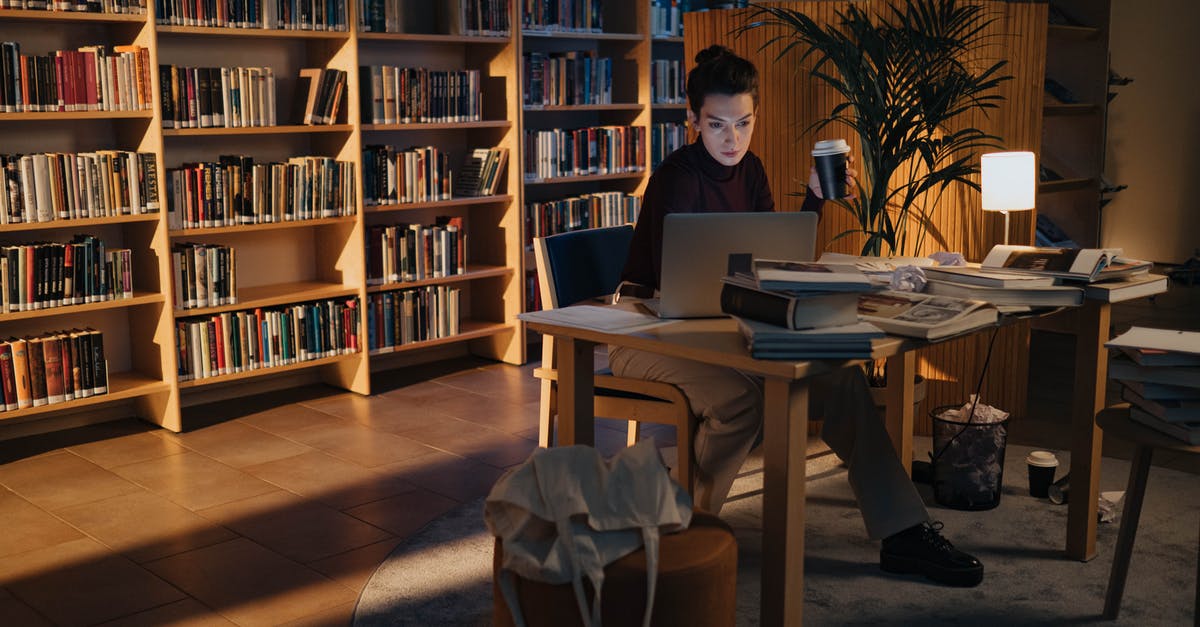 What research is there on tea preparation? - Woman Working on the Laptop in the Library While Holding a Coffee Cup What research is there on tea preparation? - Woman Working on the Laptop in the Library While Holding a Coffee Cup