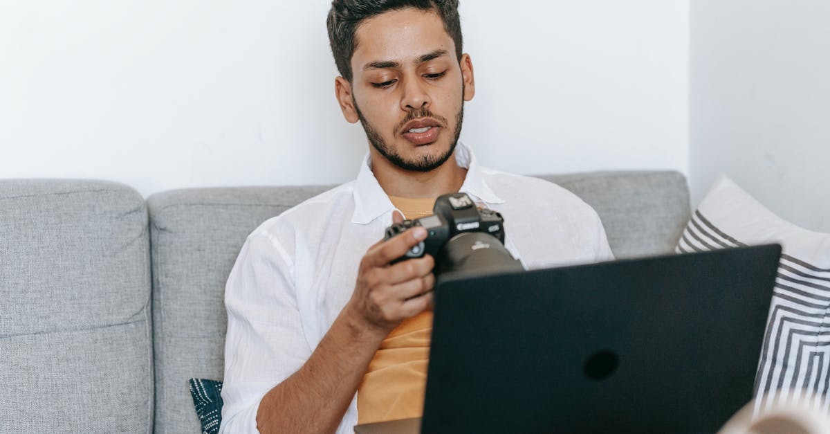 What setting on a thermomix would create a simmer? - Young bearded ethnic male photographer checking pictures on photo camera while sitting with laptop on sofa and working on freelance project What setting on a thermomix would create a simmer? - Young bearded ethnic male photographer checking pictures on photo camera while sitting with laptop on sofa and working on freelance project
