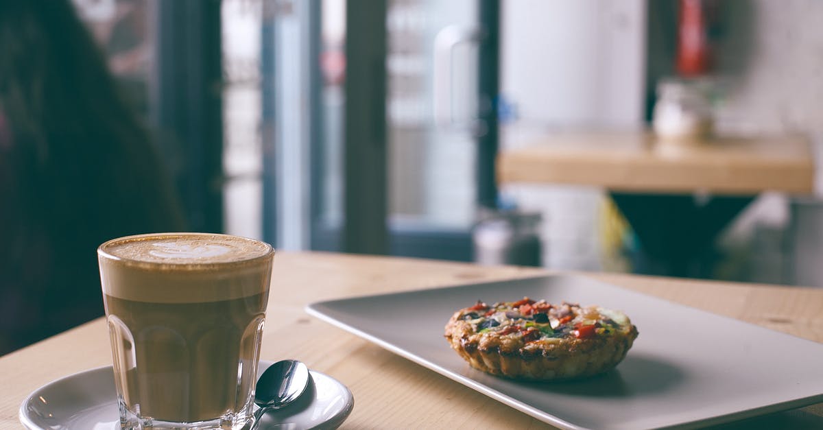 What shape is a French omelette and how is it achieved? - Glass of cappuccino near tasty frittata in cafe