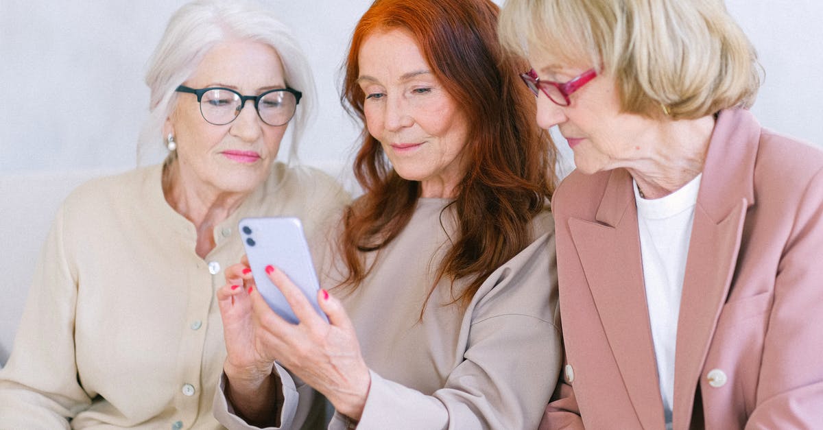 What should I check when buying a pineapple? - Aged women using smartphone together