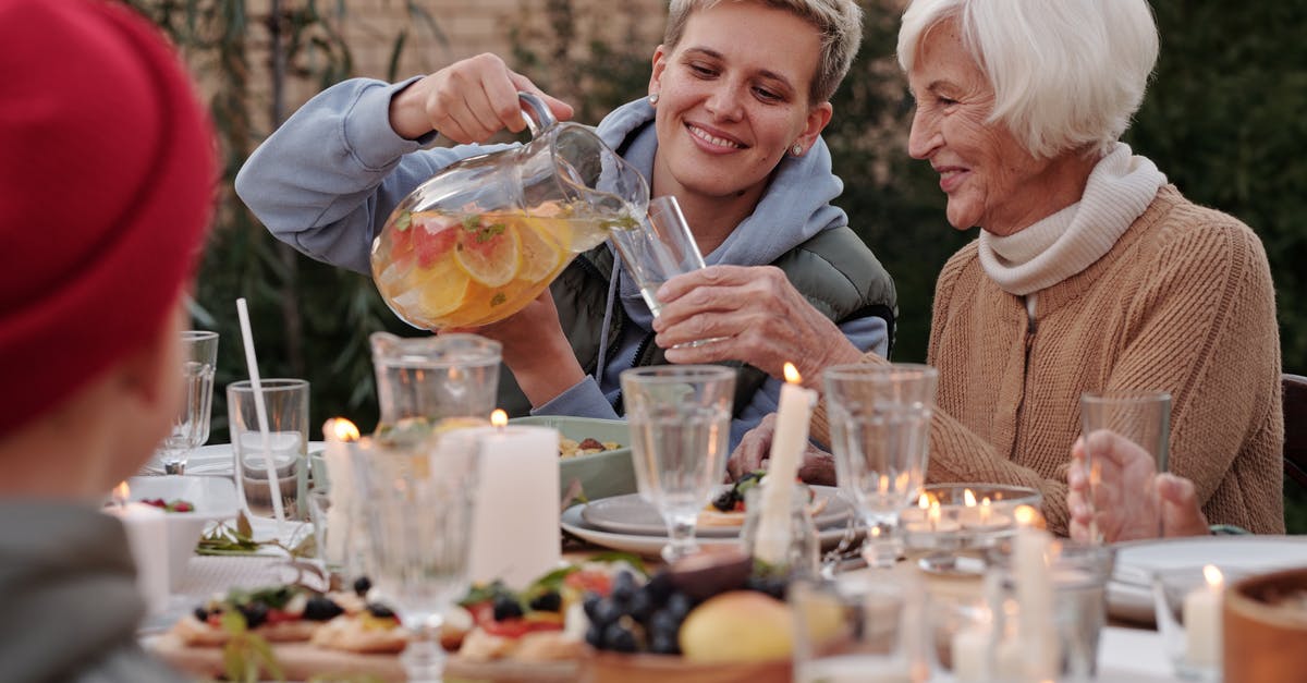 What side dish should I have with saltimbocca? - Positive lady pouring drink into glass for elderly woman while having dinner with family on terrace What side dish should I have with saltimbocca? - Positive lady pouring drink into glass for elderly woman while having dinner with family on terrace