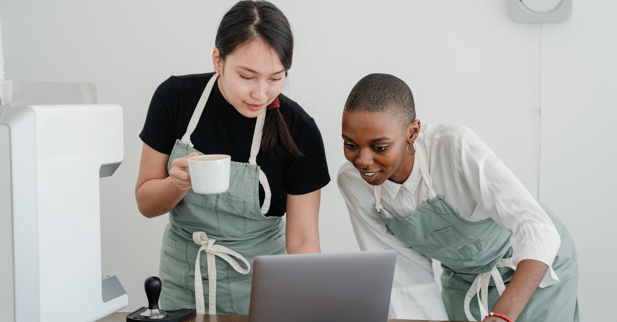 What special knowledge or skills about coffee do baristas have? - Young Asian coffee house worker explaining to new African American coworker how to use special computer program during break at work What special knowledge or skills about coffee do baristas have? - Young Asian coffee house worker explaining to new African American coworker how to use special computer program during break at work