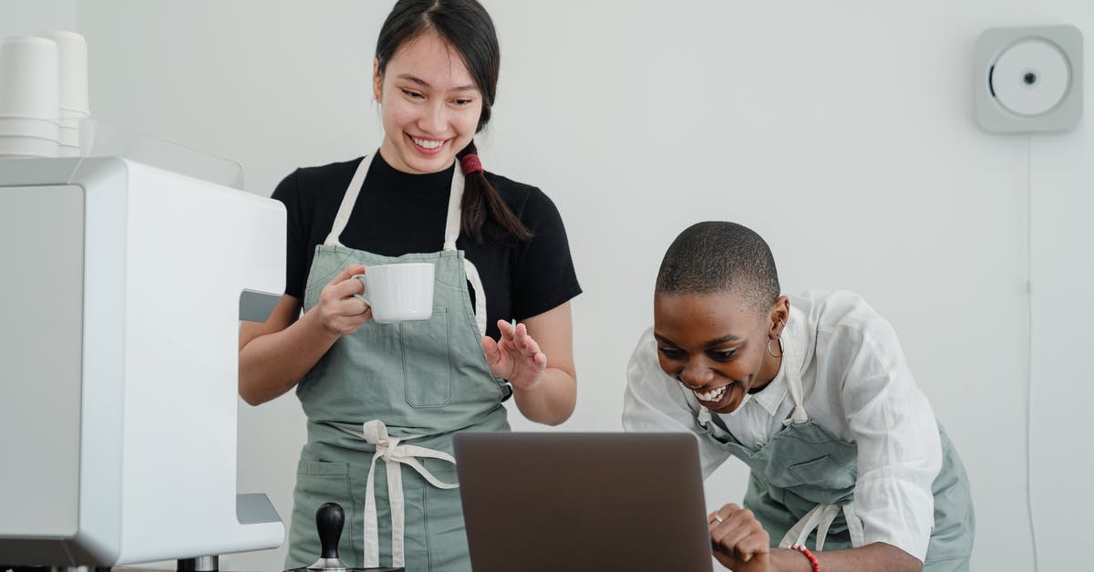 What special knowledge or skills about coffee do baristas have? - Cheerful multiracial female baristas using modern laptop during coffee break What special knowledge or skills about coffee do baristas have? - Cheerful multiracial female baristas using modern laptop during coffee break