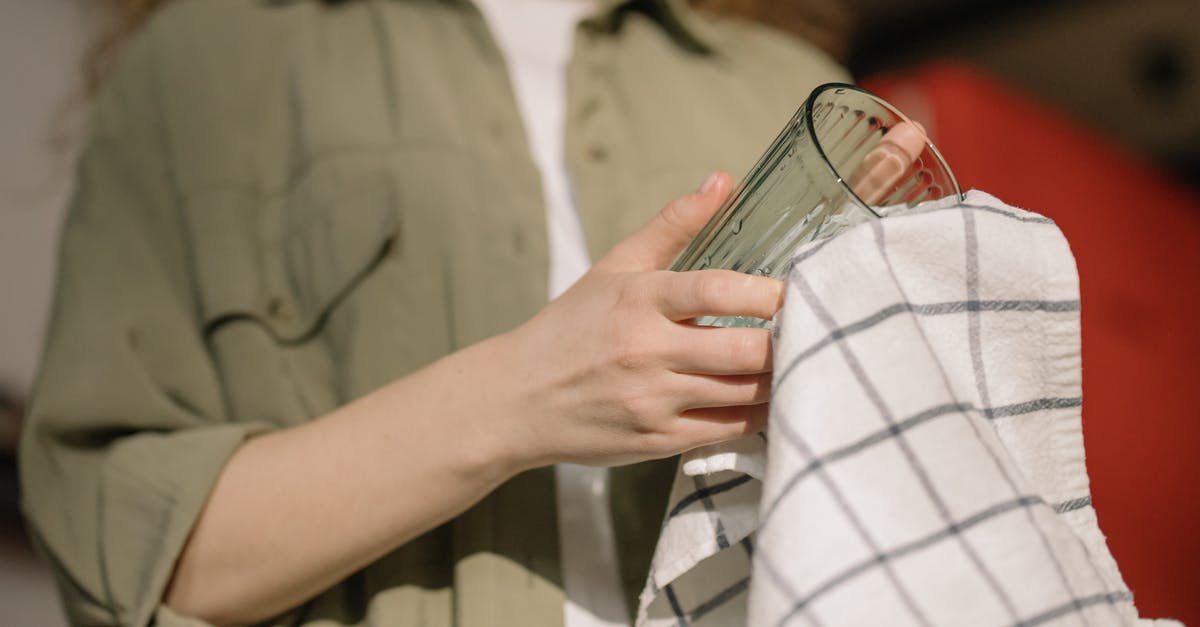 What techniques and tips do you have for keeping an organized, clean work area while you cook? [closed] - Person in Gray Button Up Shirt Holding Clear Drinking Glass