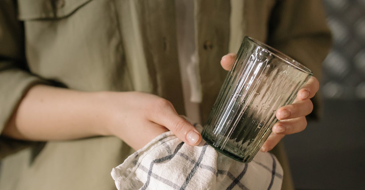 What techniques and tips do you have for keeping an organized, clean work area while you cook? [closed] - Person Holding Clear Drinking Glass