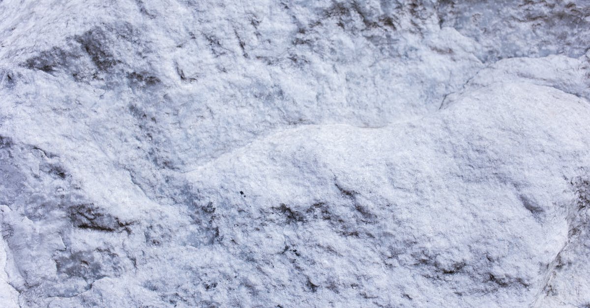 What to do with mochi...this version is white, hard and puck-like in shape? - From above of abstract background of white cracked surface rocky stone with rough texture
