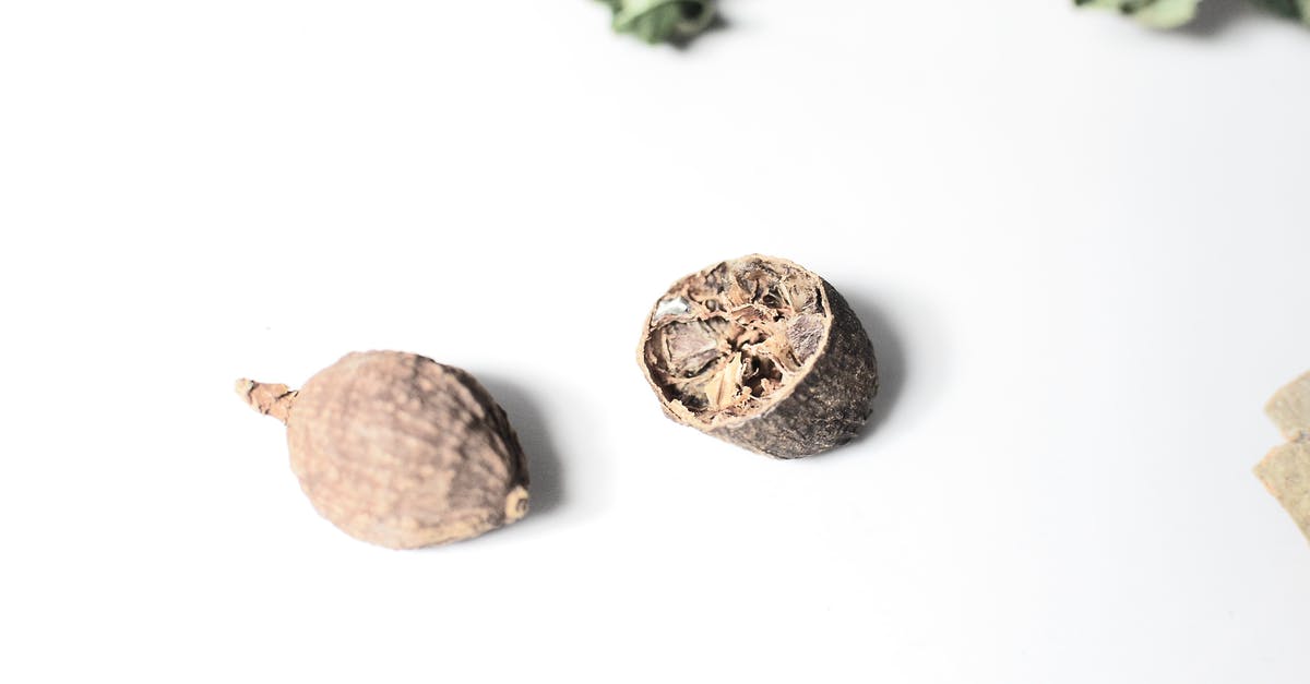 What to do with mochi...this version is white, hard and puck-like in shape? - Cracked nutmeg placed on white surface