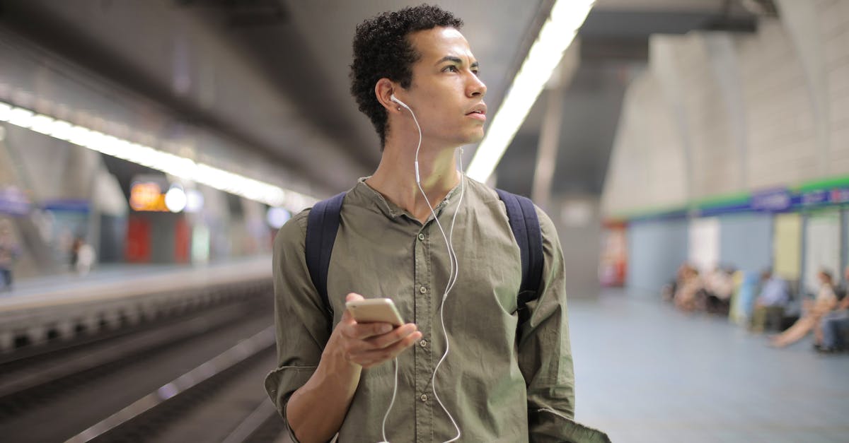 What to expect from canned bear meat? - Young ethnic man in earbuds listening to music while waiting for transport at contemporary subway station What to expect from canned bear meat? - Young ethnic man in earbuds listening to music while waiting for transport at contemporary subway station