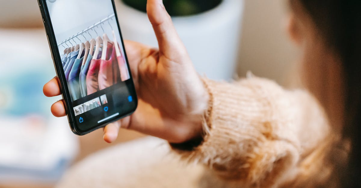 What to look for in a pot? - Faceless female looking at photos of wardrobe on phone