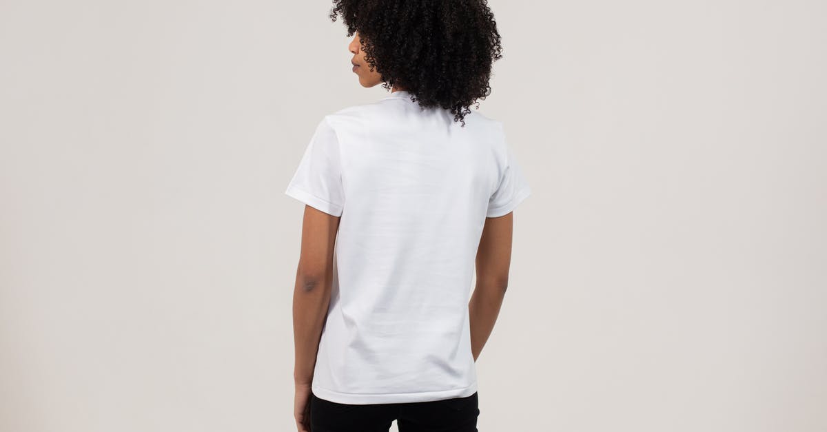 What to look for in a Stand Mixer? - Back view unemotional young African American female wearing casual white t shirt and black pants while standing against light wall What to look for in a Stand Mixer? - Back view unemotional young African American female wearing casual white t shirt and black pants while standing against light wall