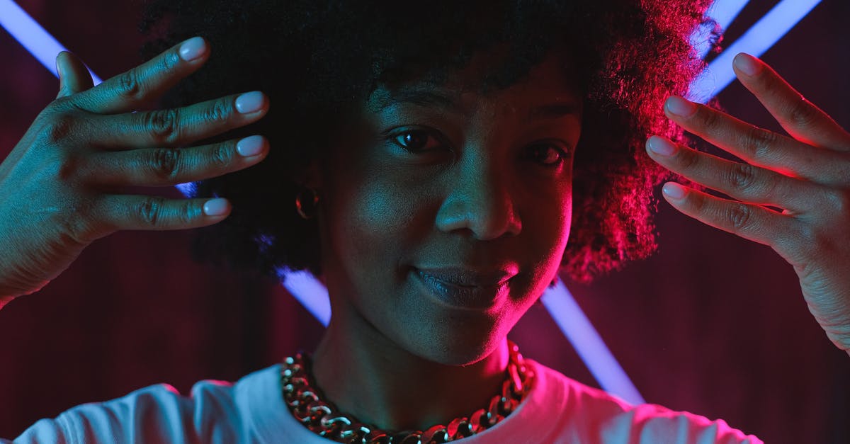 What to look in a truly dishwasher friendly non-stick cookware? - Cheerful black woman raising hands near face in neon illumination What to look in a truly dishwasher friendly non-stick cookware? - Cheerful black woman raising hands near face in neon illumination