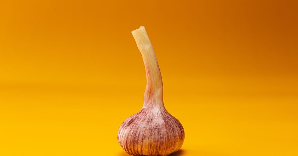 What turned my garlic purple? - Brown Wooden Spoon on Yellow Surface What turned my garlic purple? - Brown Wooden Spoon on Yellow Surface