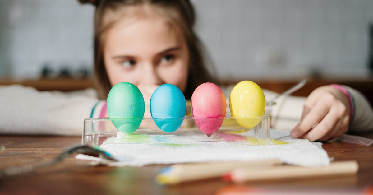What will happen if I leave out hardboiled eggs in water for four weeks? - Four Colored Eggs on Palette Tray 