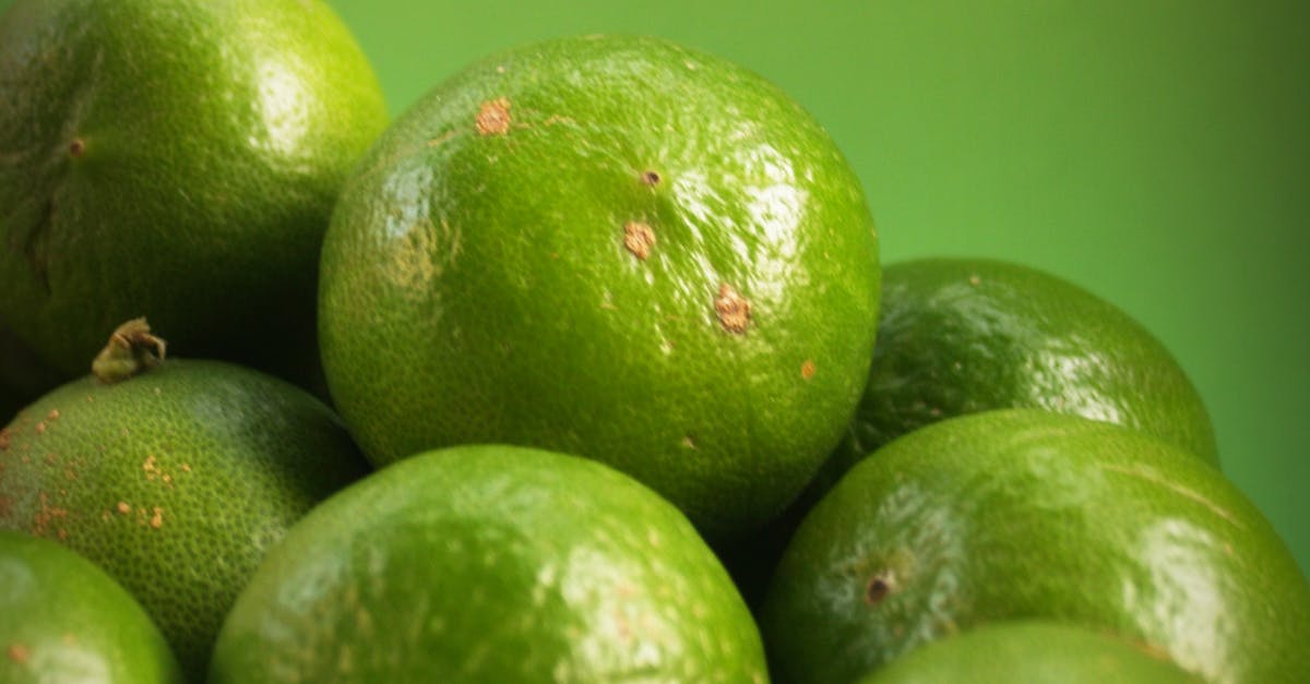 What would cause the peel of a lime to turn yellow? - Closeup Photography of Limes What would cause the peel of a lime to turn yellow? - Closeup Photography of Limes