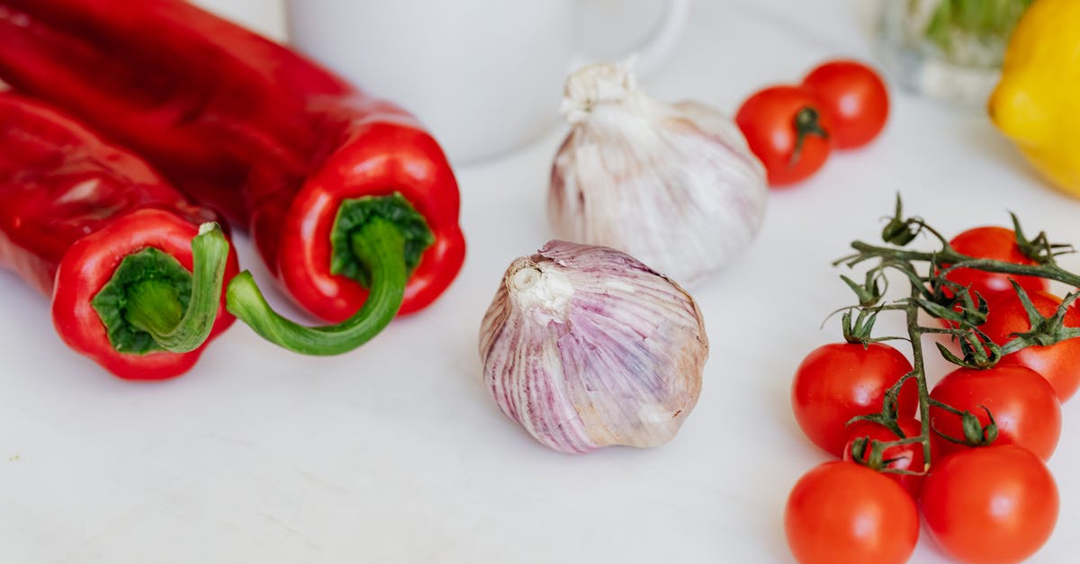 What would convert this chili recipe into a Russian chili? - Fresh garlic placed among ripe red cherry tomatoes and peppers on white table near white ceramic cup and yellow lemon What would convert this chili recipe into a Russian chili? - Fresh garlic placed among ripe red cherry tomatoes and peppers on white table near white ceramic cup and yellow lemon
