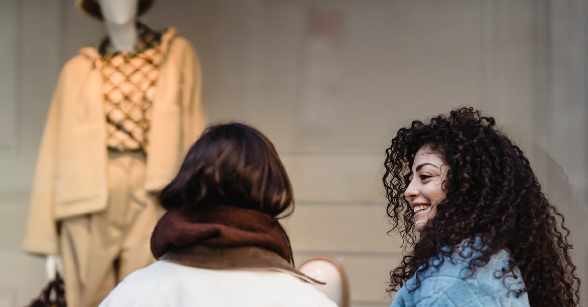 When's the best time to buy a Thanksgiving turkey? - Content young ethnic women smiling at street while looking at trendy clothes on mannequin When's the best time to buy a Thanksgiving turkey? - Content young ethnic women smiling at street while looking at trendy clothes on mannequin