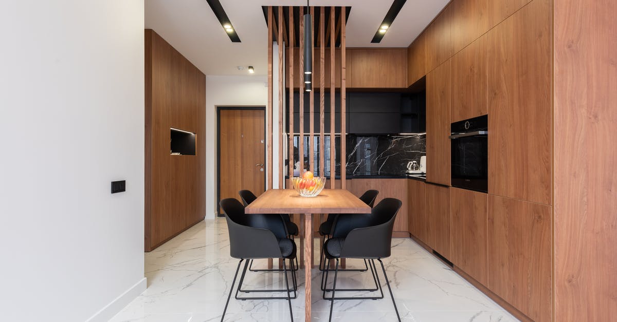 When does the new home oven/stove smell go away? - Stylish kitchen with wooden furniture and dining zone When does the new home oven/stove smell go away? - Stylish kitchen with wooden furniture and dining zone