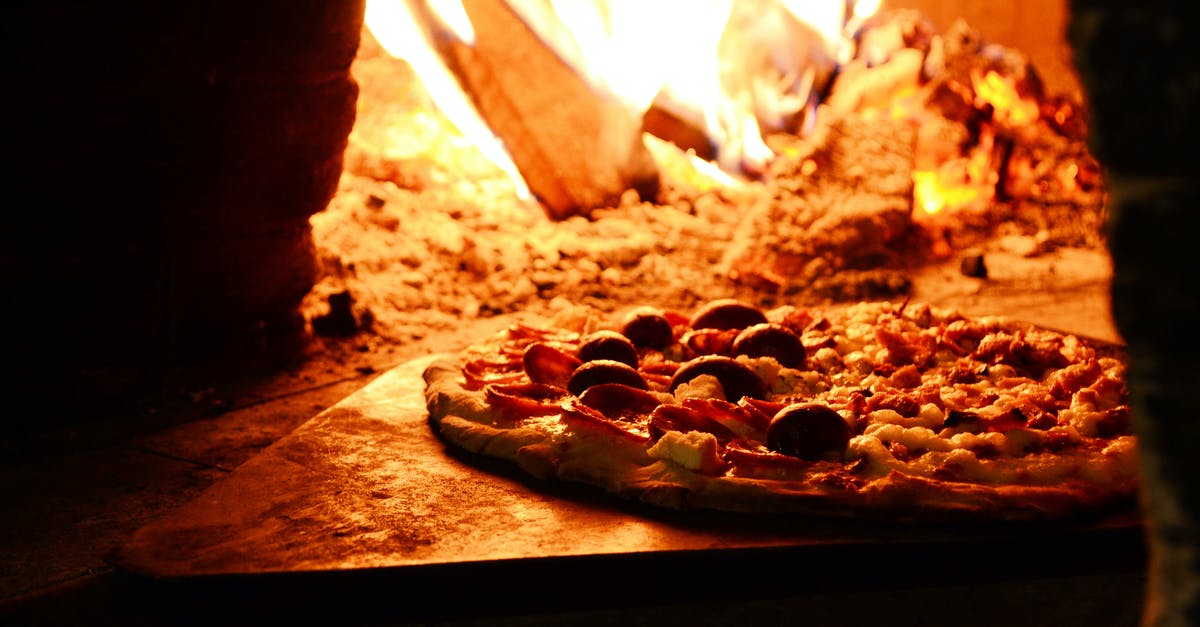When heating up a pizza, edges burn while middle still liquid - Close-up Photo of Pizza Near Bonfire When heating up a pizza, edges burn while middle still liquid - Close-up Photo of Pizza Near Bonfire