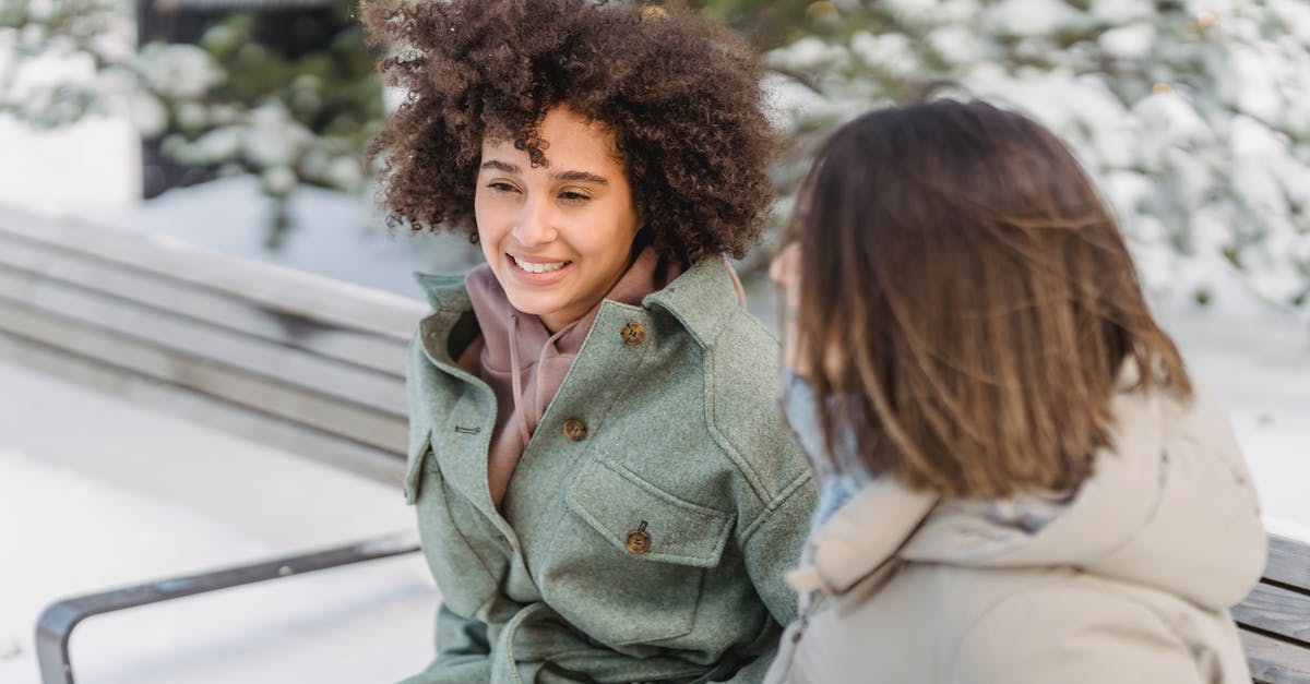 When is the best time to freeze bread? - High angle of positive African American female with curly hair sitting on bench near girlfriend while spending time in winter park When is the best time to freeze bread? - High angle of positive African American female with curly hair sitting on bench near girlfriend while spending time in winter park