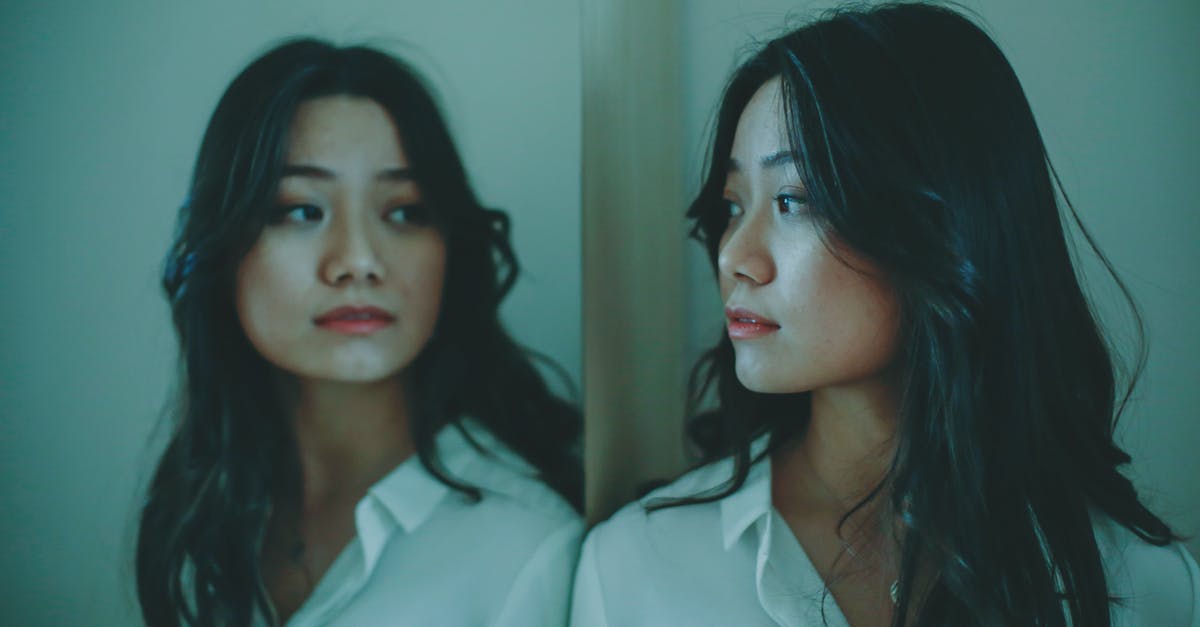 Where do you want 90% lean beef? - Young Asian female looking at reflection Where do you want 90% lean beef? - Young Asian female looking at reflection