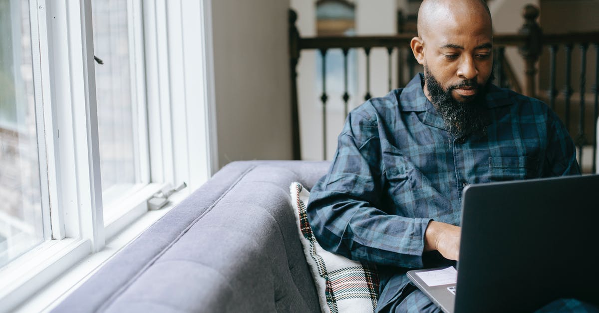 Where to learn what ratios to use in cooking? - Serious black man using laptop at home Where to learn what ratios to use in cooking? - Serious black man using laptop at home