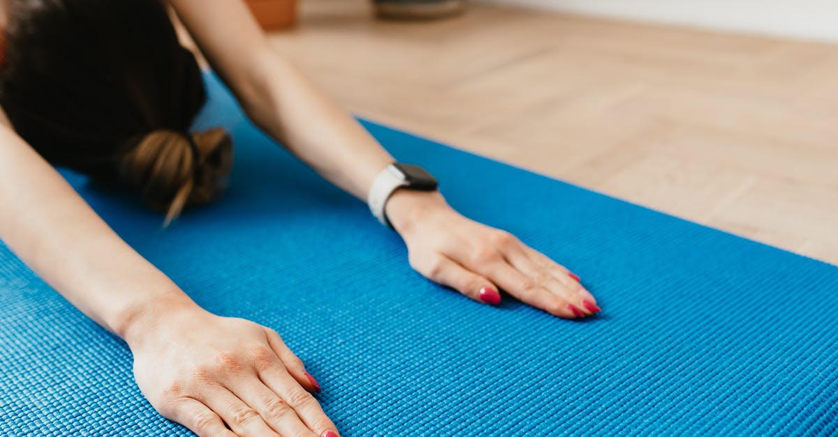 Which cooking device allows flexible temperature programming? - Crop anonymous woman practicing yoga on mat at home Which cooking device allows flexible temperature programming? - Crop anonymous woman practicing yoga on mat at home