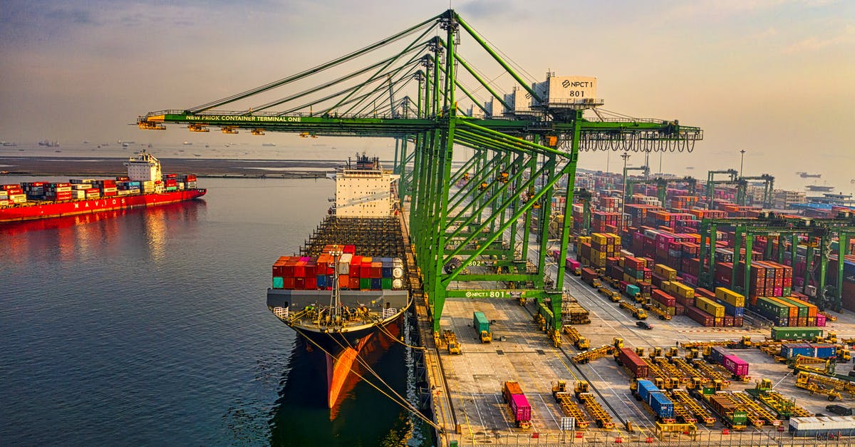 Which kinds of vessels insulate well? - Drone Shot of a Docked Cargo Ship at a Port Which kinds of vessels insulate well? - Drone Shot of a Docked Cargo Ship at a Port