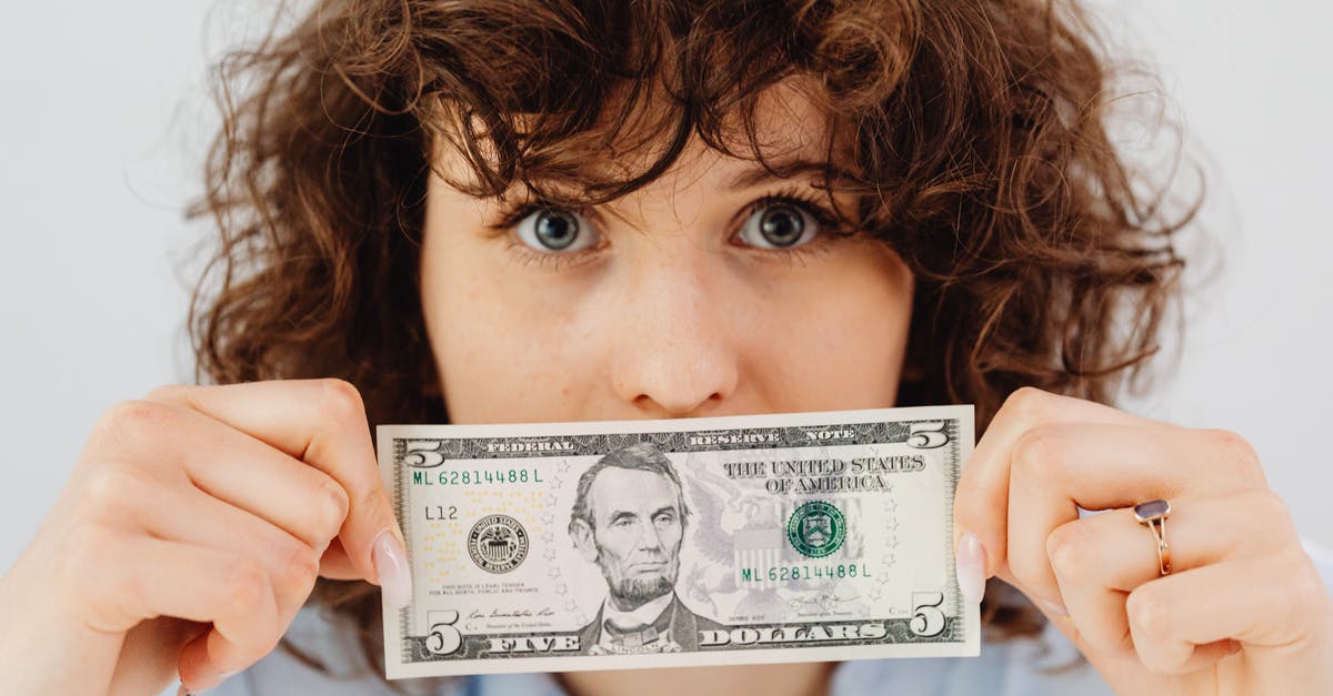 Which side of the baking paper should face up? - Woman Holding a Five Dollar Bill Which side of the baking paper should face up? - Woman Holding a Five Dollar Bill
