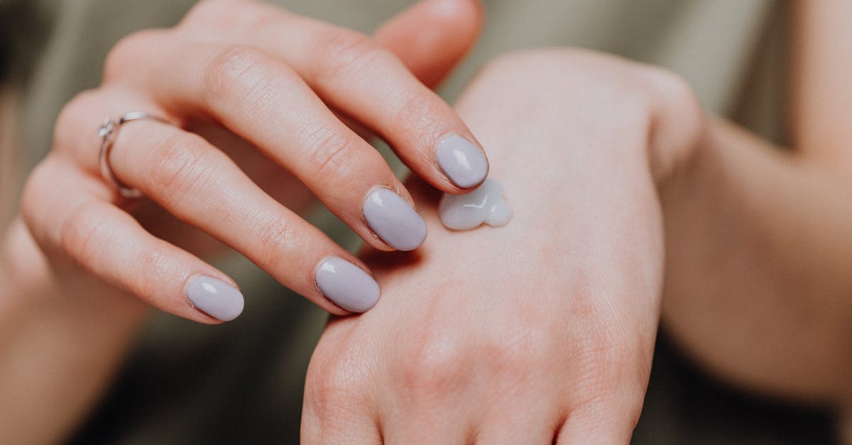 Which vinegars are essential to keep on hand? - Crop woman with ring applying hand cream