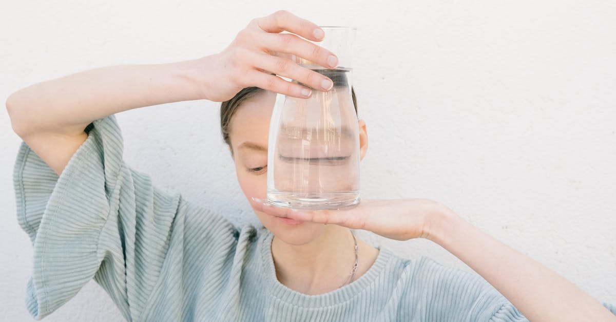 Whiskey and Water - Woman in Blue Crew Neck Shirt Holding Clear Glass Jar Whiskey and Water - Woman in Blue Crew Neck Shirt Holding Clear Glass Jar