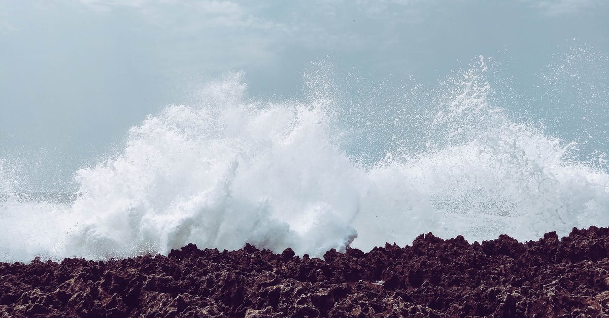 White cloud of foam while fermenting tepache - Picturesque view of white foamy waves splattering near ocean shore with rough surface under cloudy sky in daylight in stormy weather