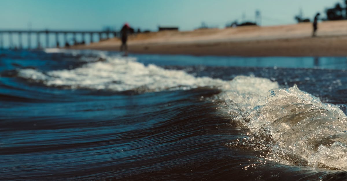 White cloud of foam while fermenting tepache - Ocean wave with foam against beach in daylight