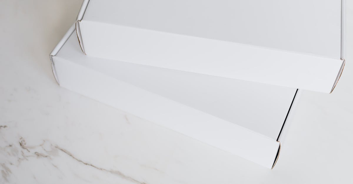 White ganache from cocoa butter won't set - Set of white carton packages on marble surface White ganache from cocoa butter won't set - Set of white carton packages on marble surface