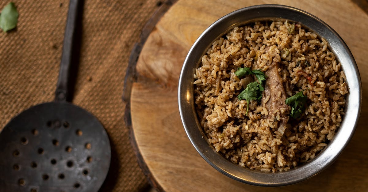 Why are holes punched into rice packages? - A Bowl of Rice and Meat on the Wooden Table Why are holes punched into rice packages? - A Bowl of Rice and Meat on the Wooden Table