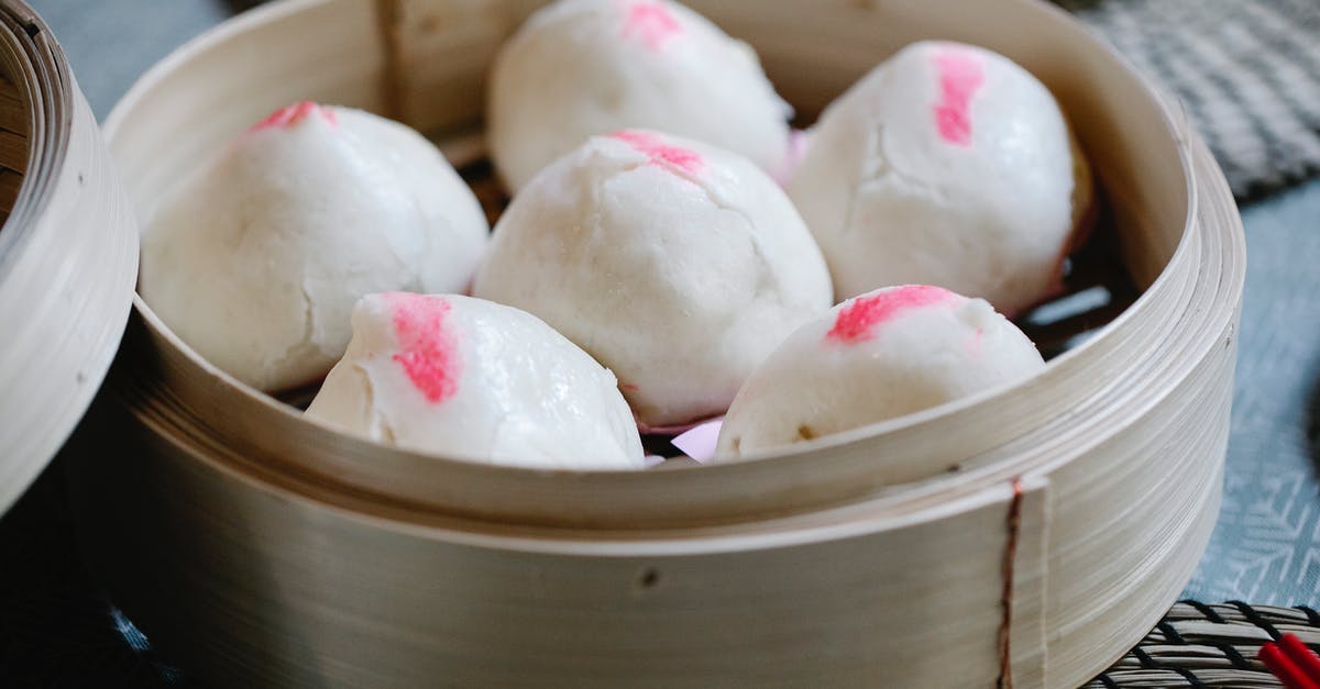 Why are my Baozi shrinking? - From above of raw Chinese homemade bao in bamboo steamer prepared for traditional lunch Why are my Baozi shrinking? - From above of raw Chinese homemade bao in bamboo steamer prepared for traditional lunch